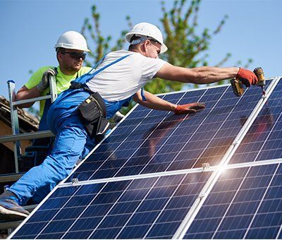two men installing solar panels on a roof