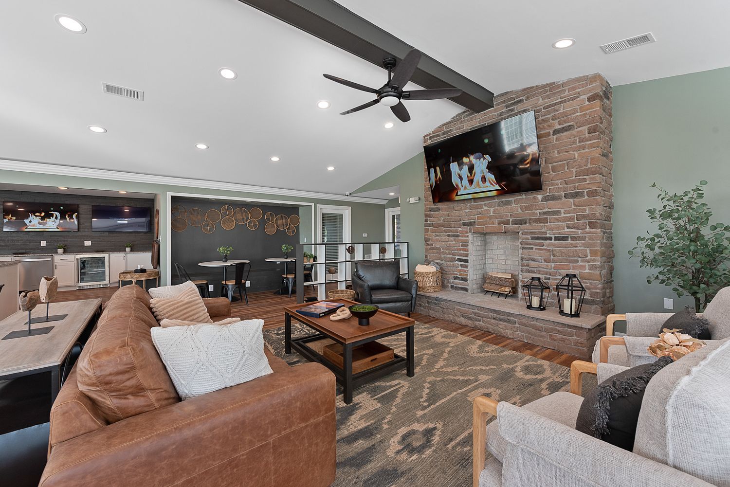 Bridgewater Crossing clubhouse with cozy couches, stone fireplace, and open layout.