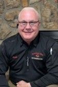 Portrait of a smiling exterminator, wearing a black uniform, from a local pest control company. Portrait of a smiling exterminator, wearing a black uniform, from a local pest control company.