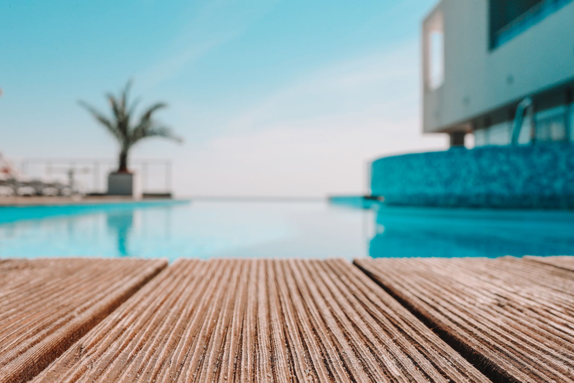 Empty wooden deck with swimming pool Empty wooden deck with swimming pool