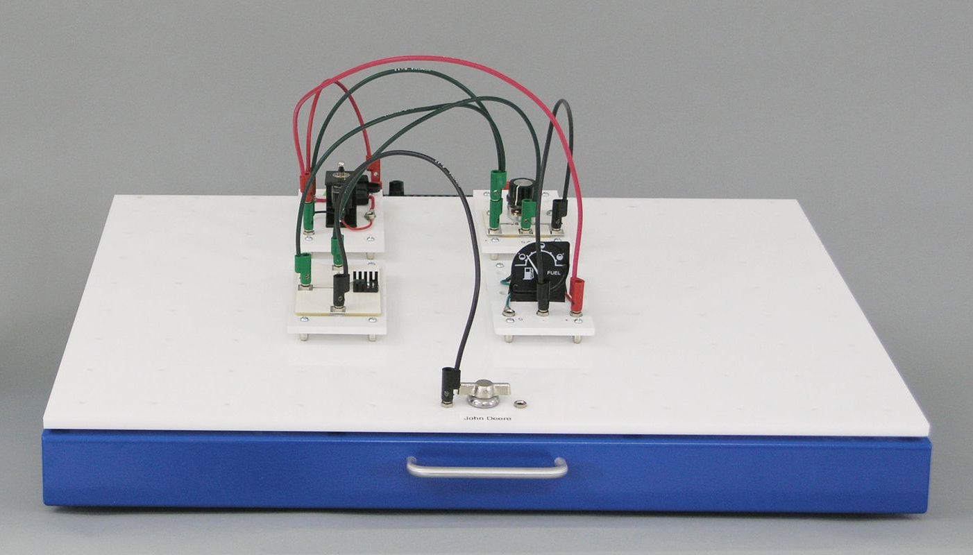A white and blue tray with a bunch of wires on it