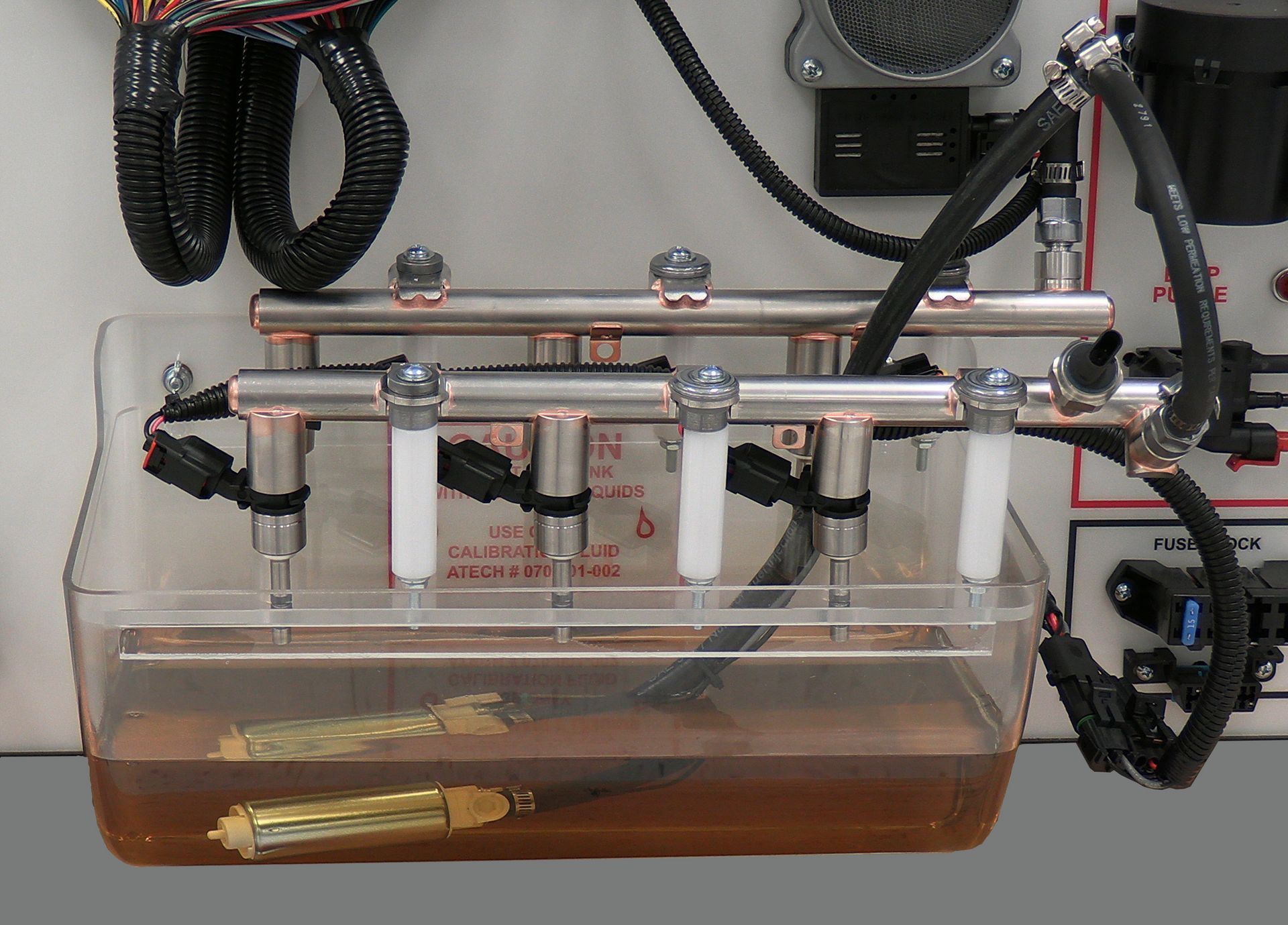 A clear plastic container filled with a brown liquid