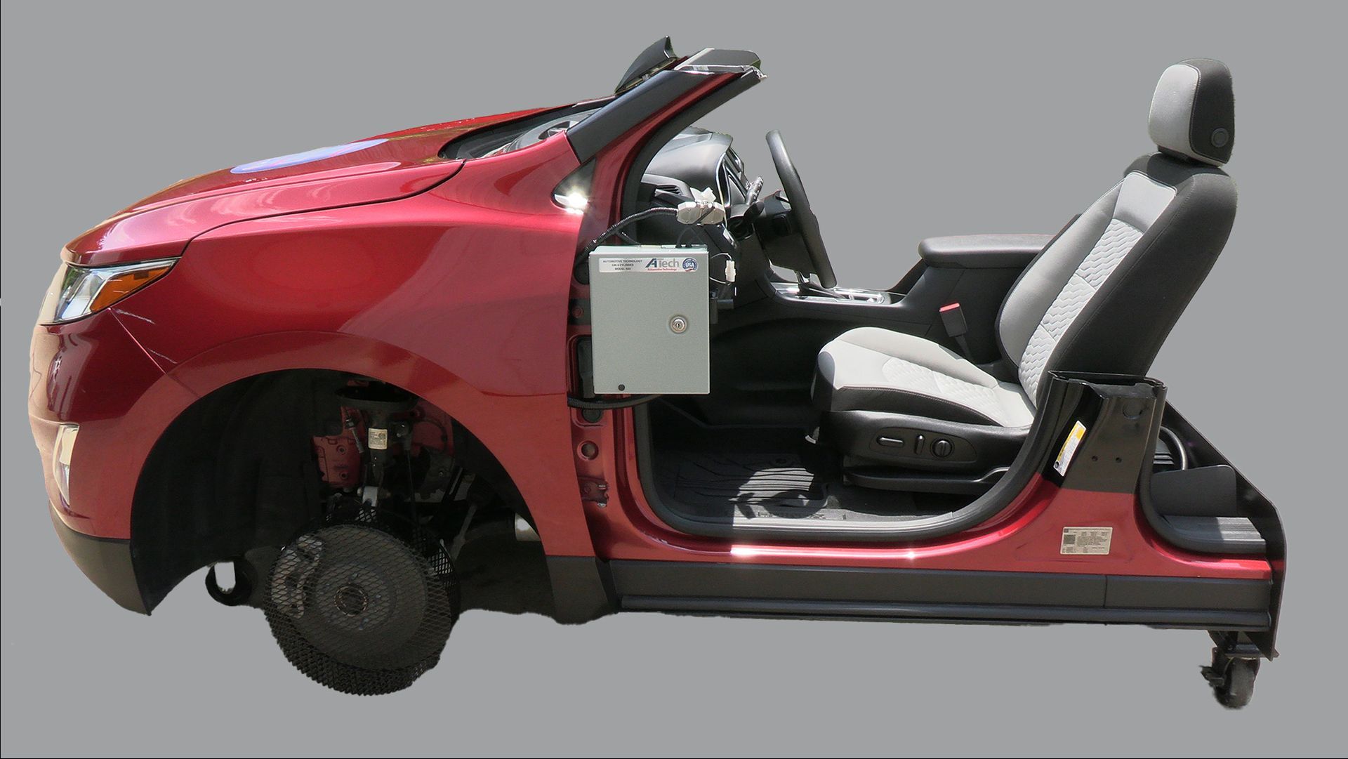 A red car is sitting on a cart with the door open