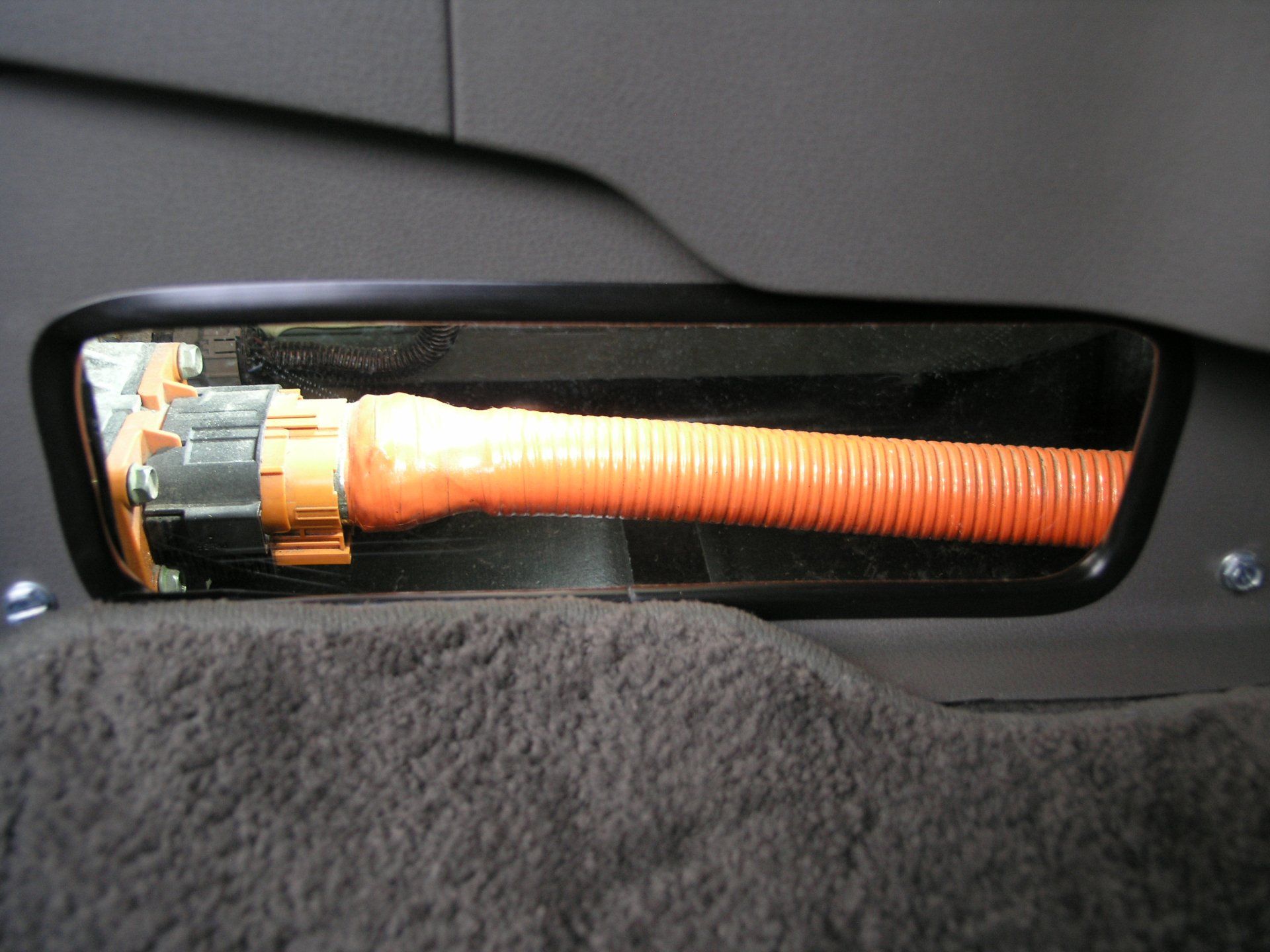 A close up of an orange hose in a car