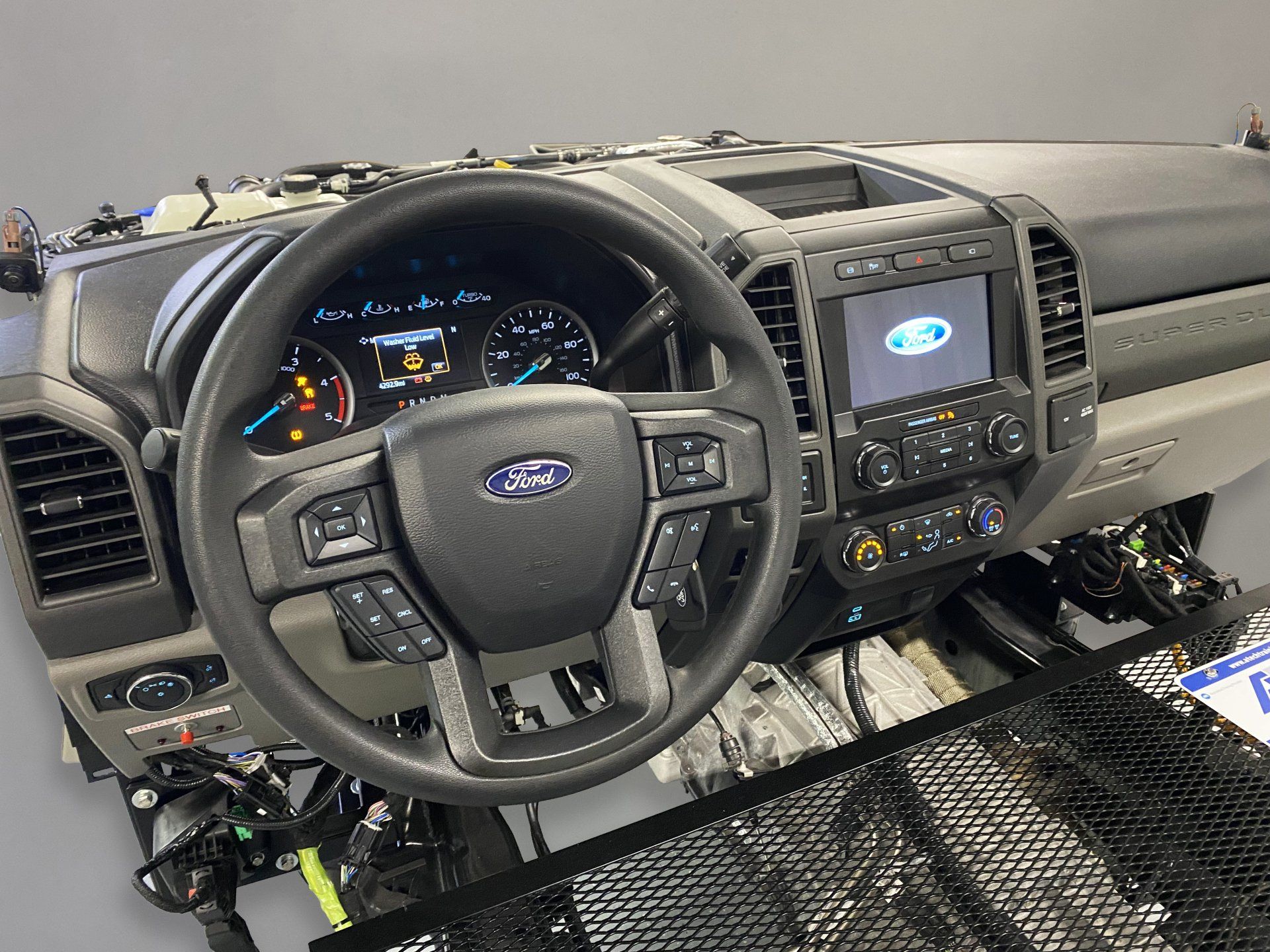 The interior of a ford truck with the steering wheel removed