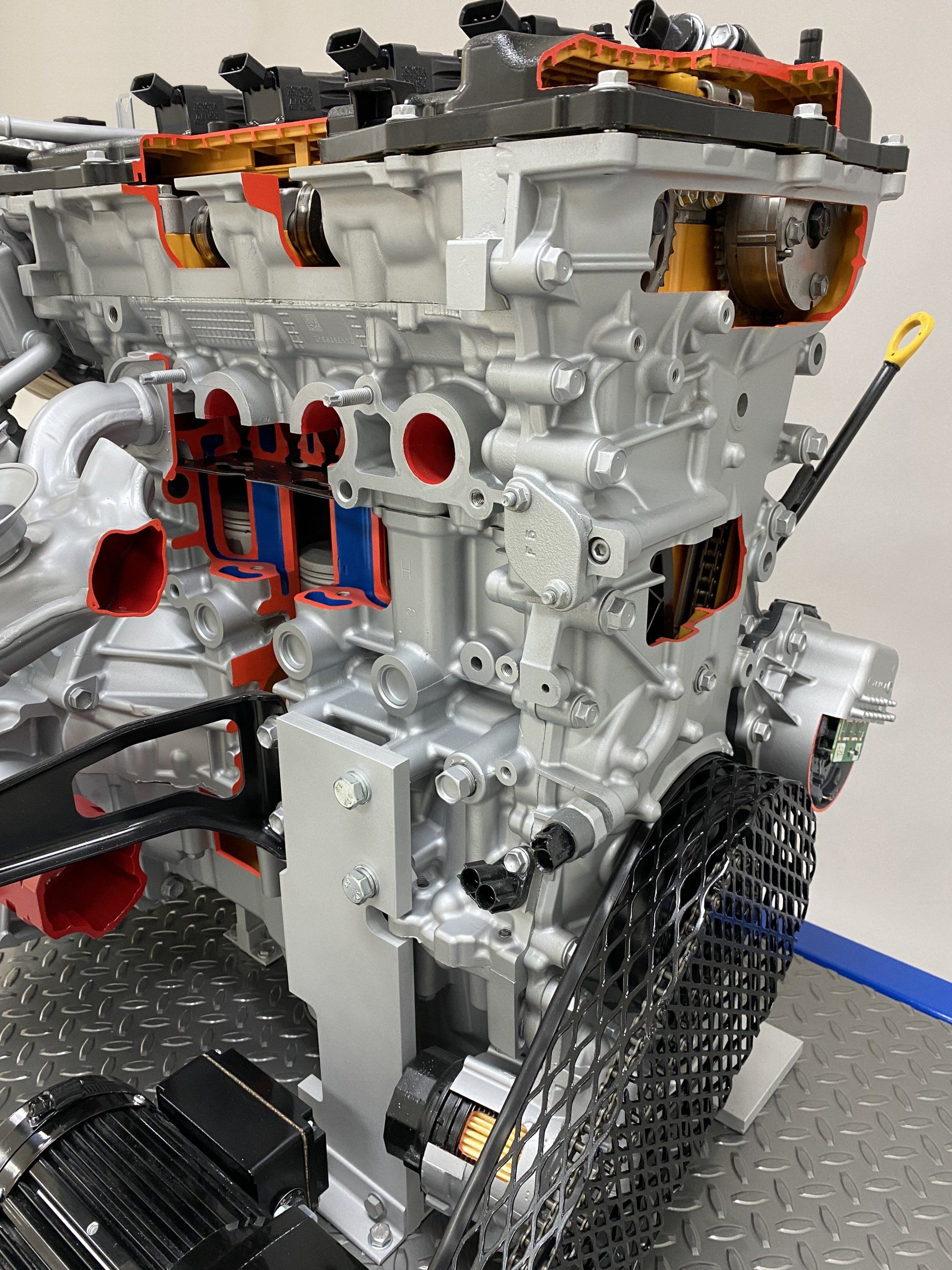 A close up of a cut in half engine on a table.