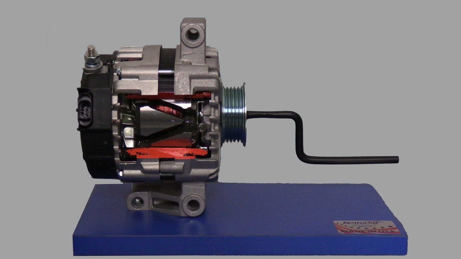 A model of an alternator with a wrench attached to it