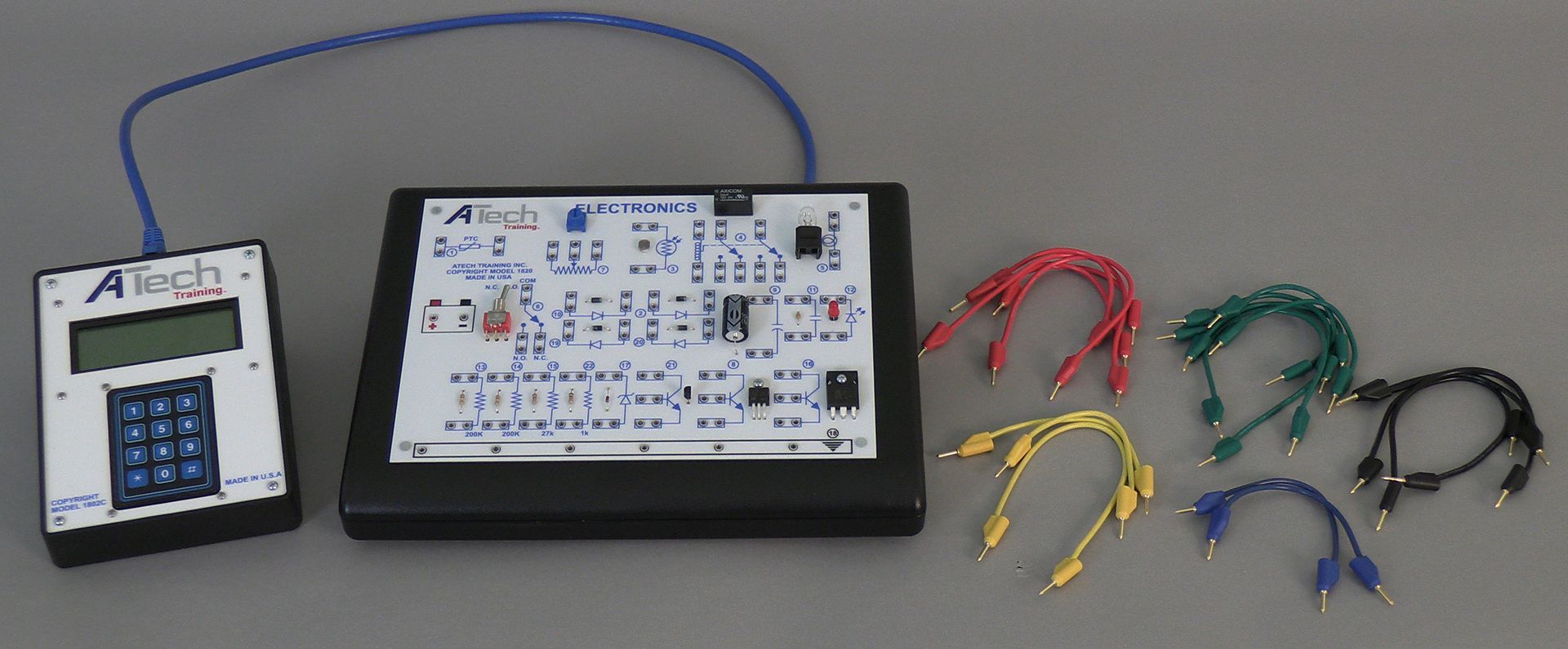 A calculator is connected to a circuit board with wires
