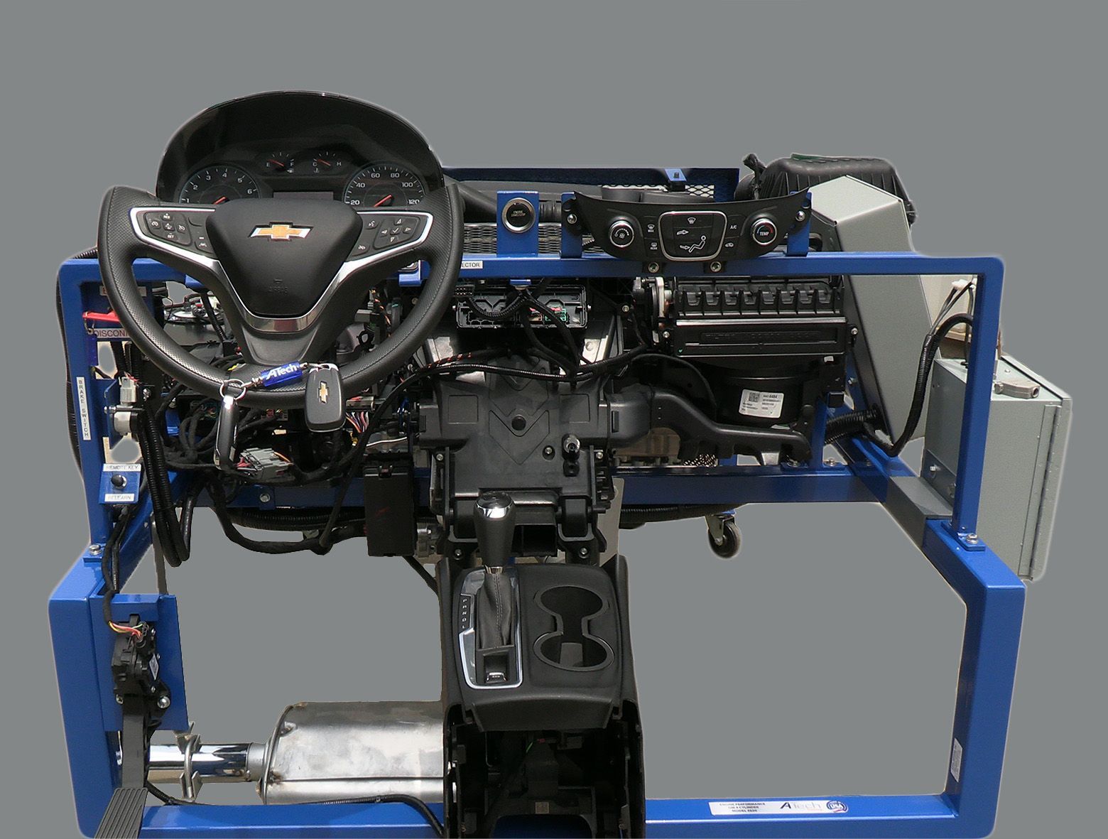 A steering wheel is sitting on top of a blue frame.