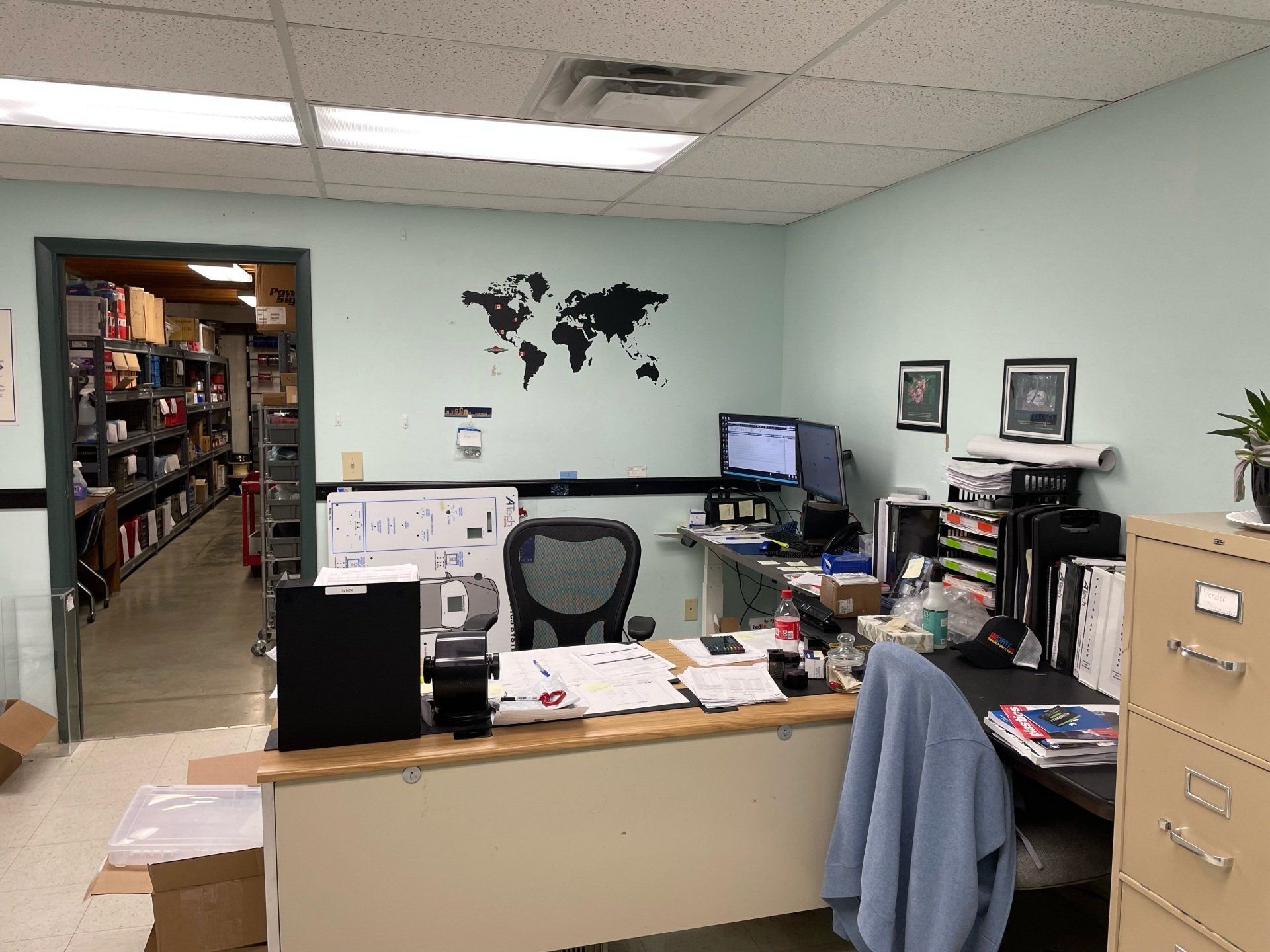 An office with a desk and chair and a map on the wall
