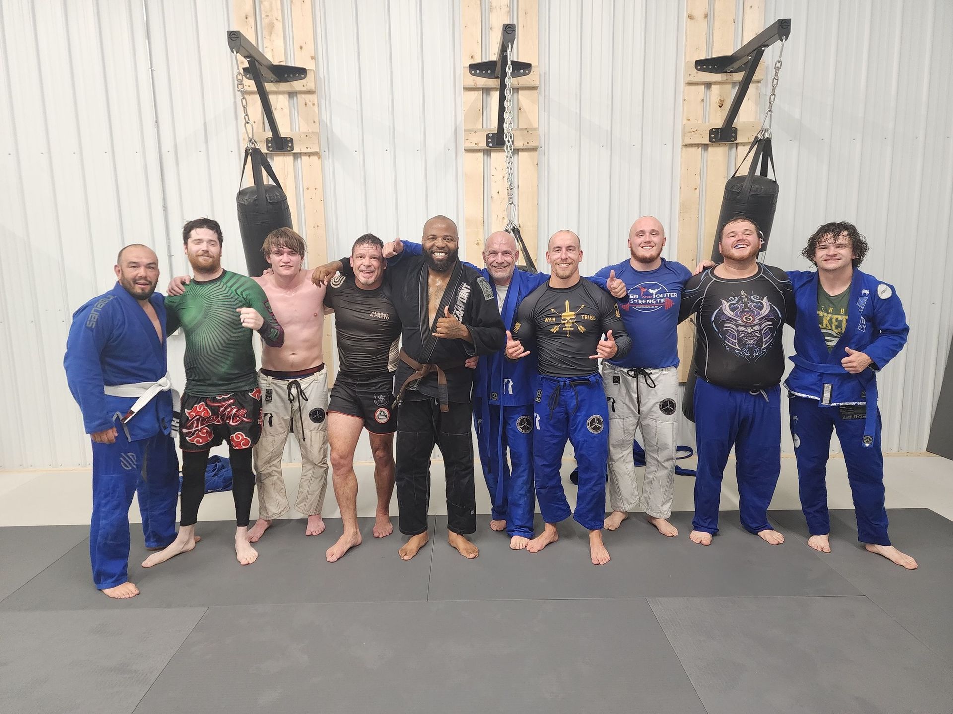 A group of men are posing for a picture in a gym.