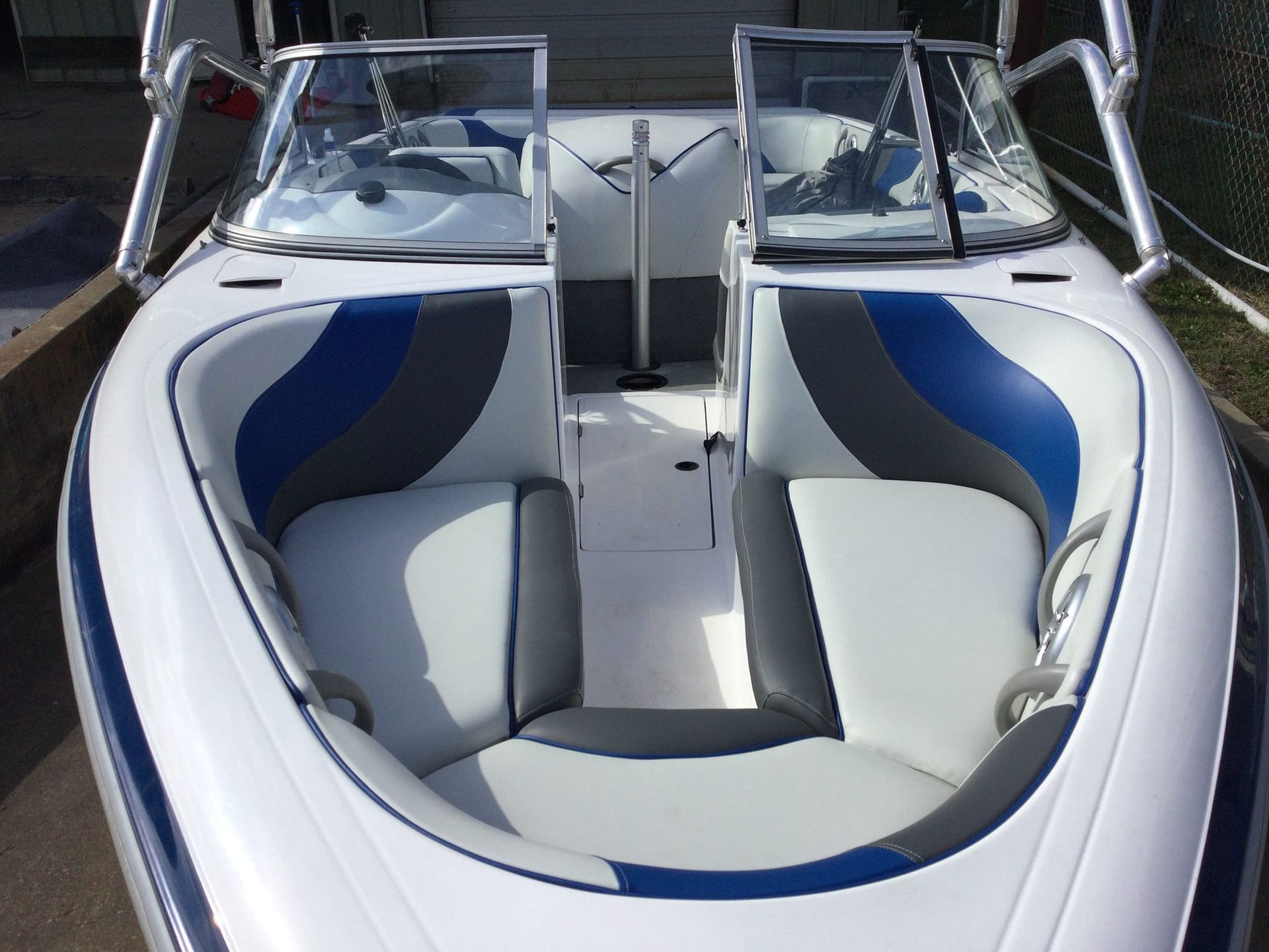 White boat interior with blue and gray seats.