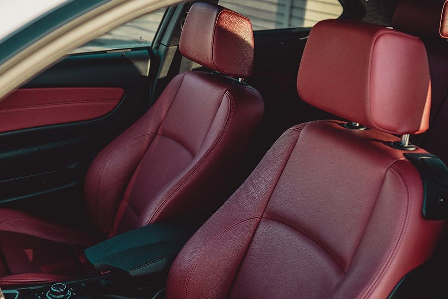 Red leather car seats inside a vehicle.