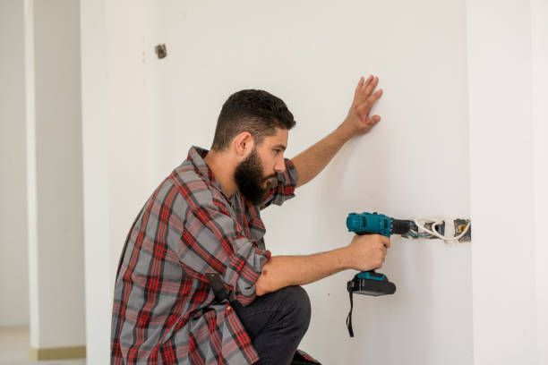 Conway Electric technician performing lighting system repair in Albuquerque, NM, installing a new li