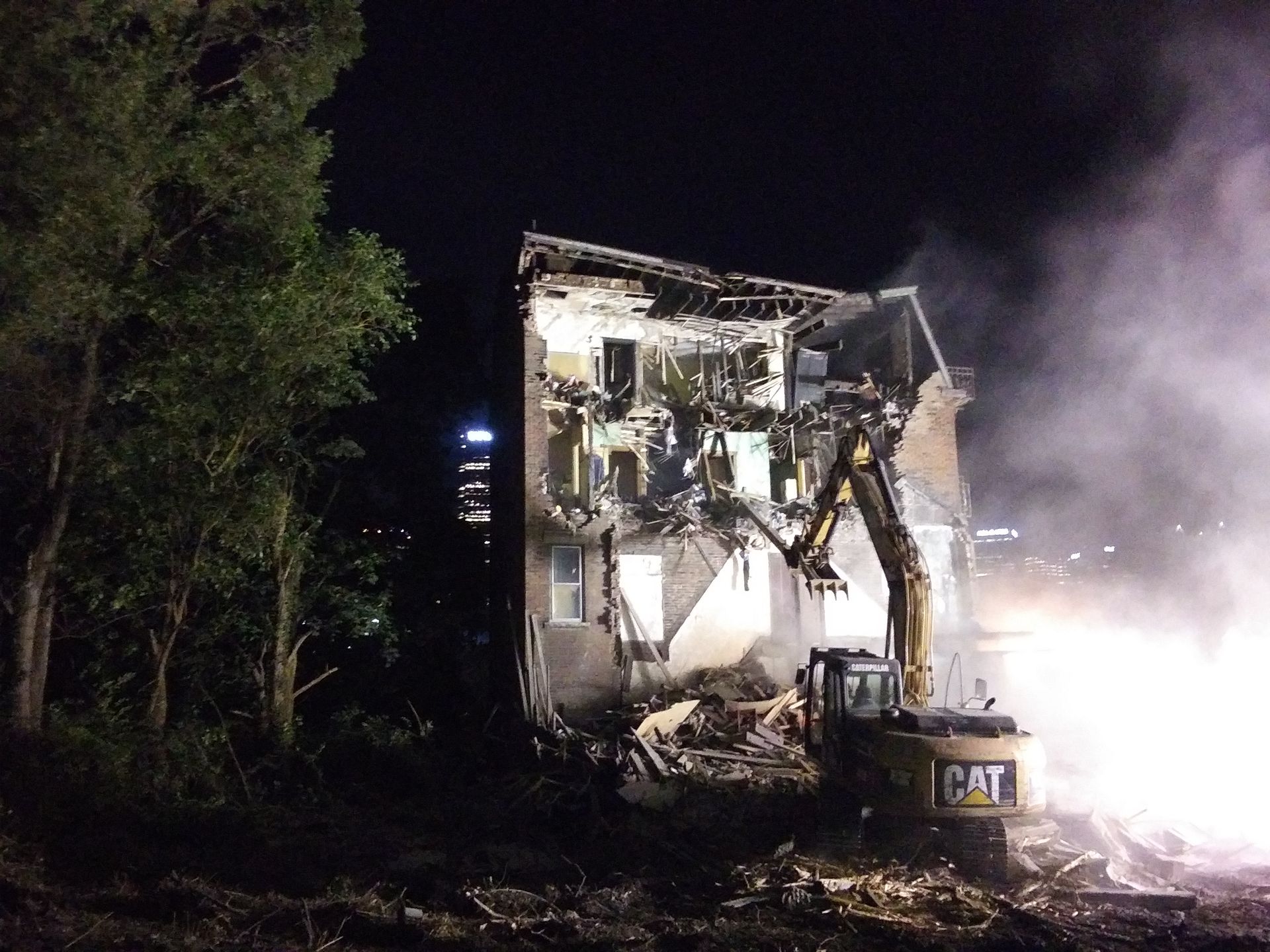 excavator razing a condemned home