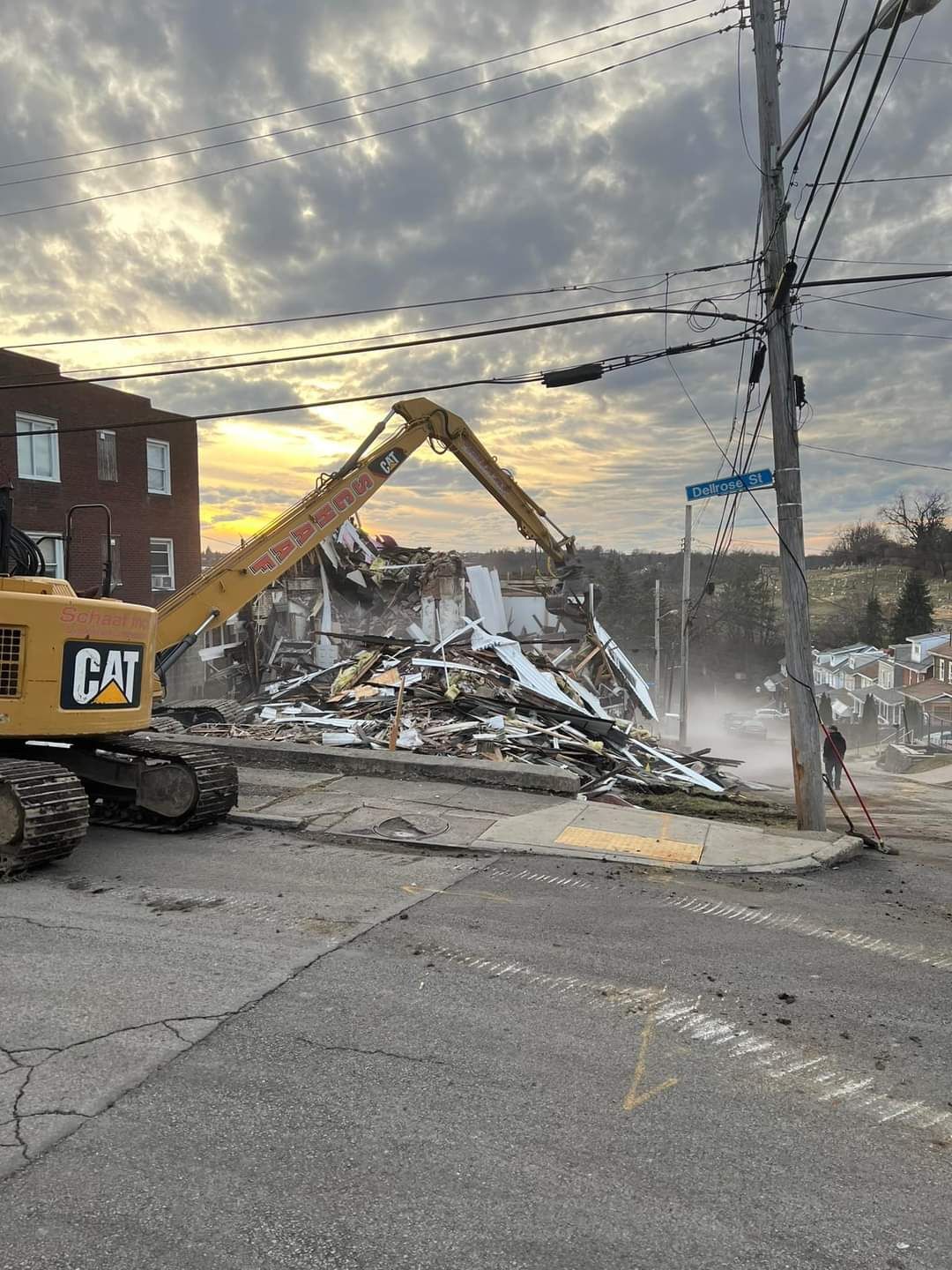 excavator demoing a residential property