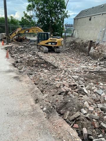 excavator clearing a lot