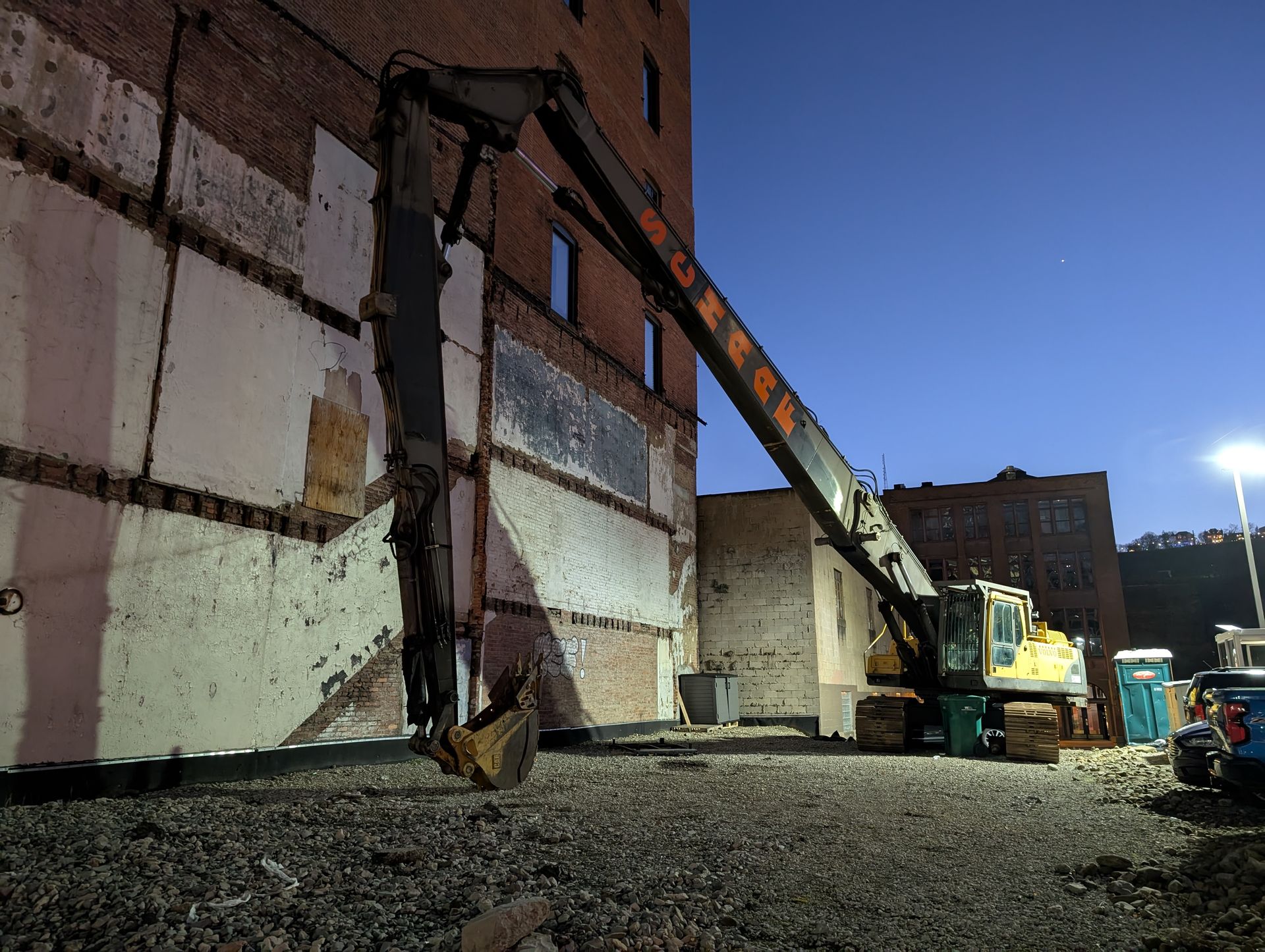 schaaf long reach excavator outside industrial building demolition site in Pittsburgh