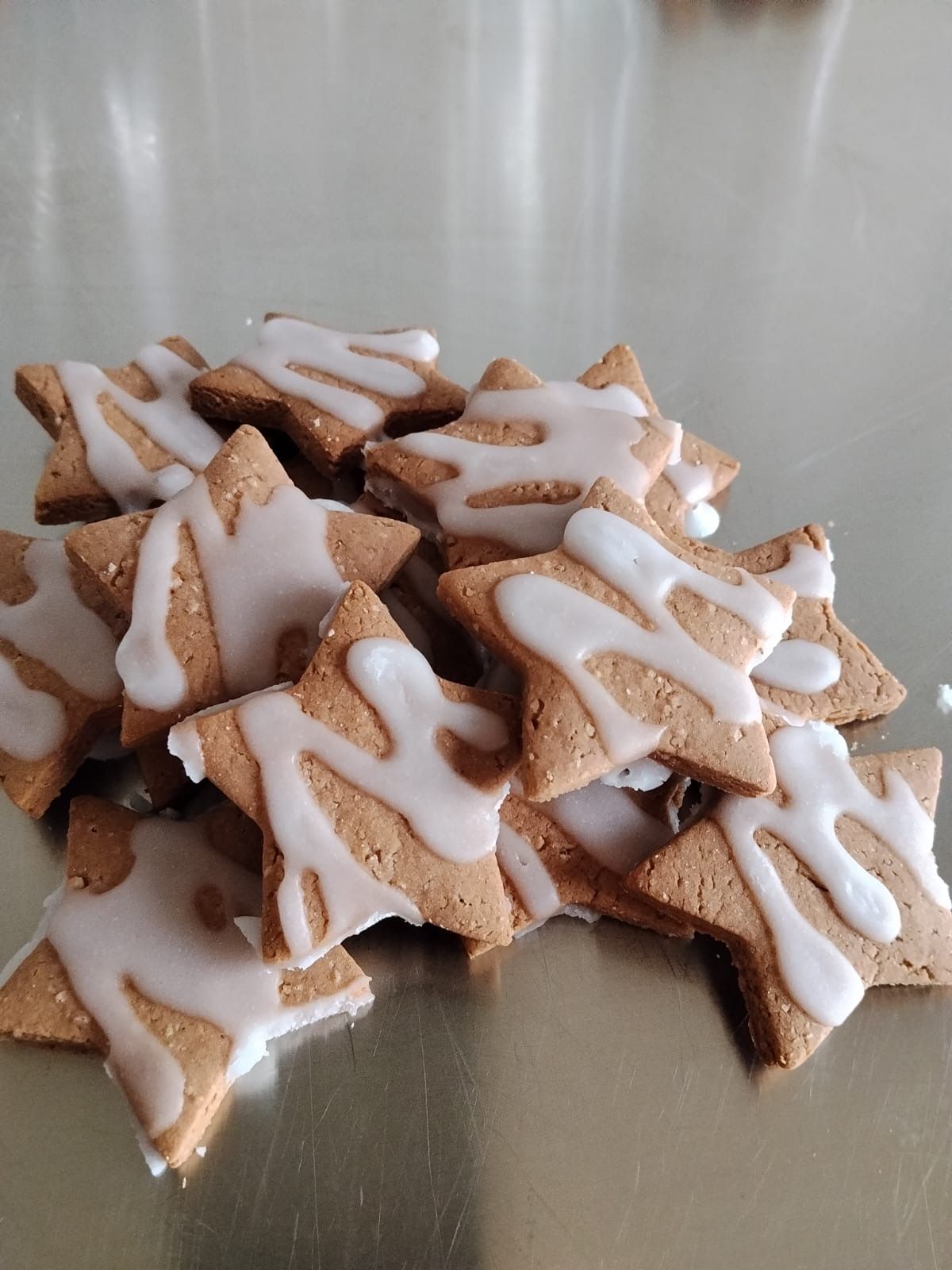 Pila di biscotti a forma di stella allo zenzero glassati su un piatto