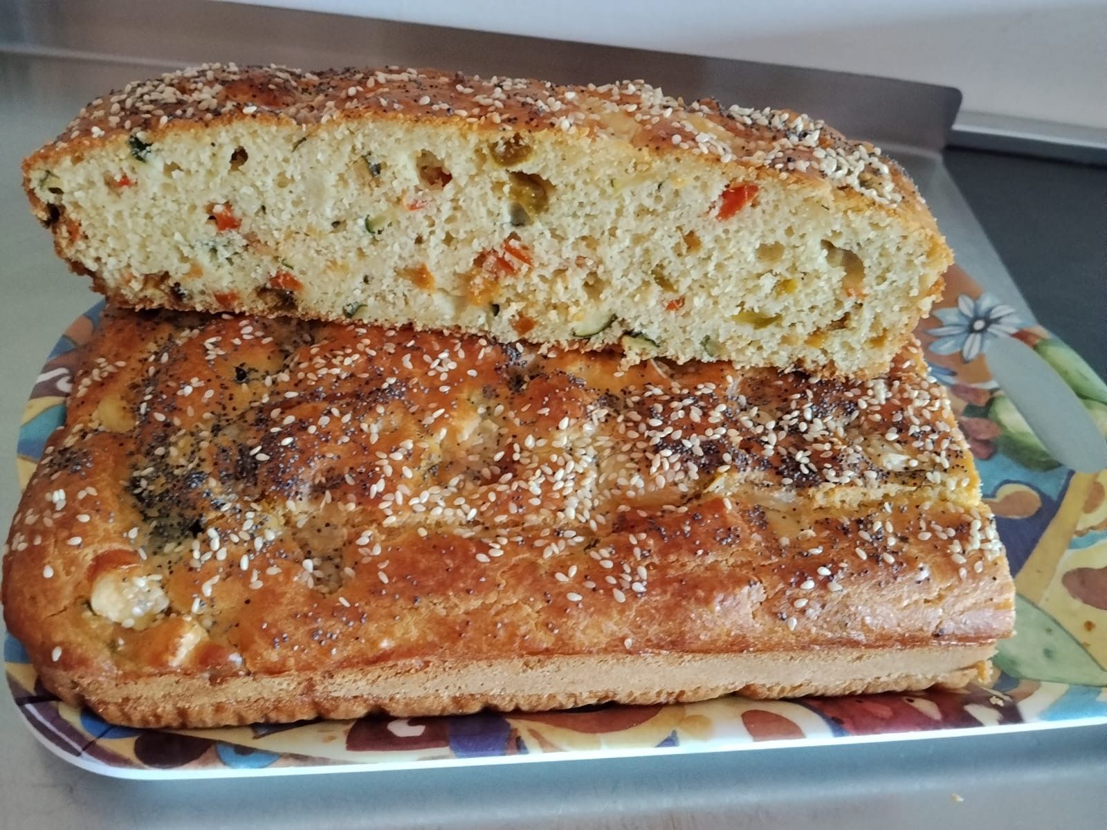 Due fette di pane ai semi con un ripieno colorato di verdure su un piatto