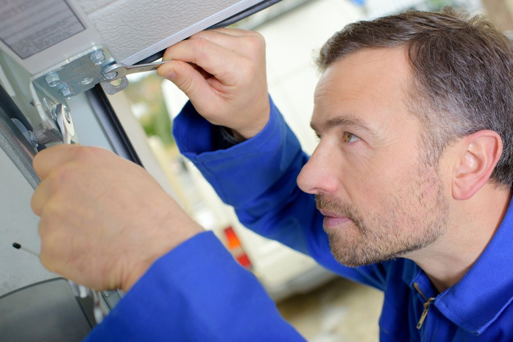 Man Installing A Garage Door — Internal, Entrance & Garage Door Installation in Mackay, QLD
