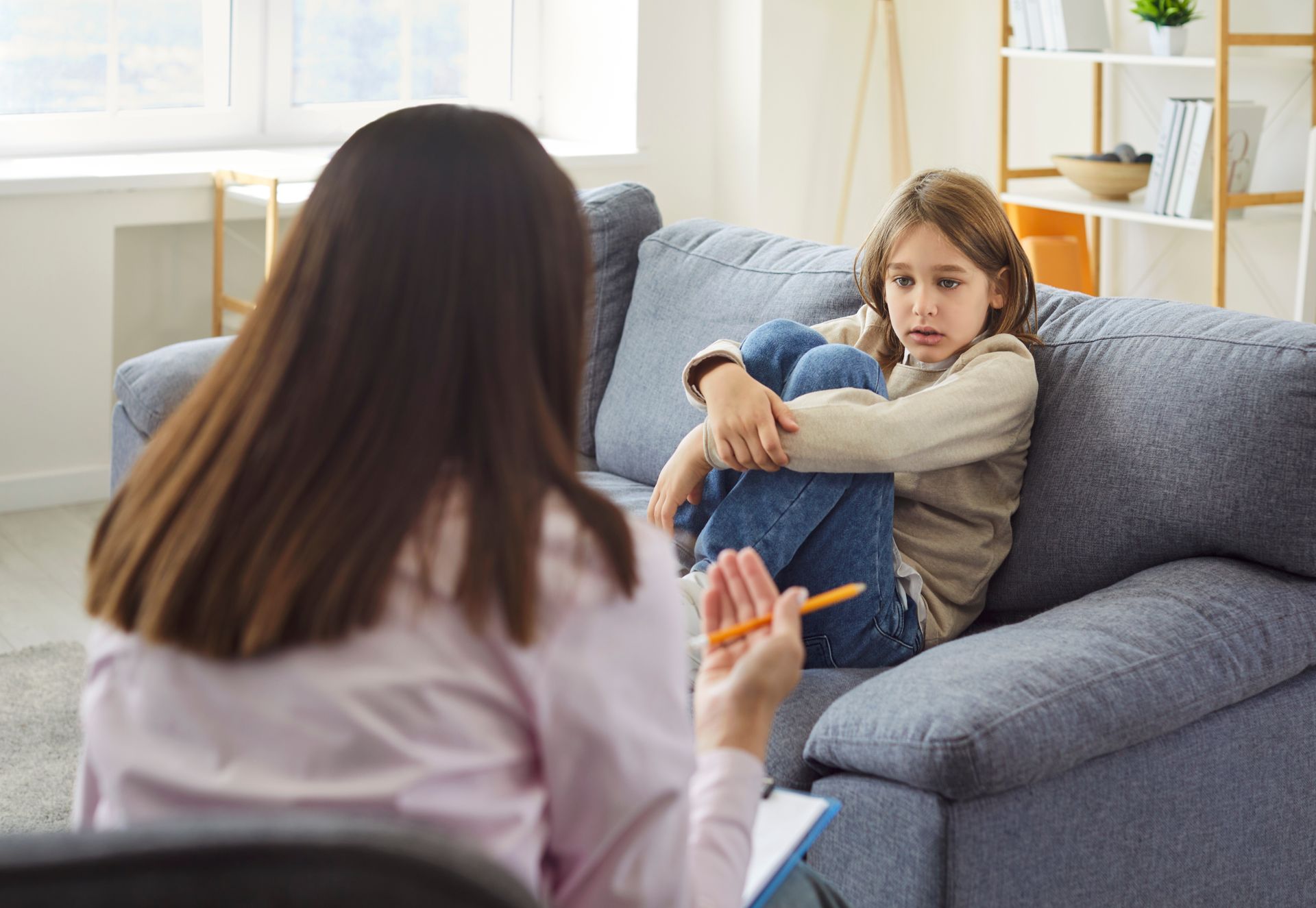 People seated in a circle during a group discussion or therapy session