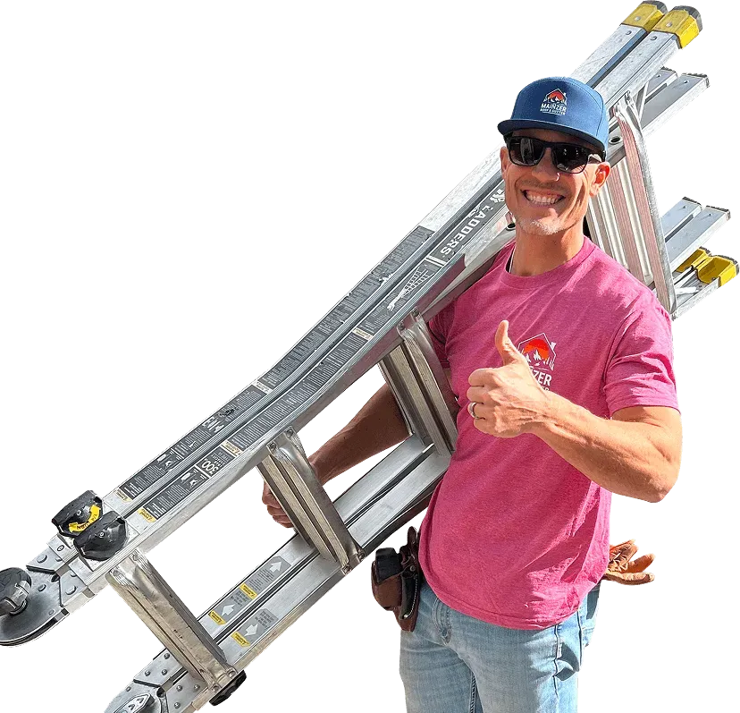 Man in pink shirt and blue cap carrying a ladder, smiling and giving a thumbs-up.