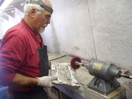 a man in a red shirt is working on a machine