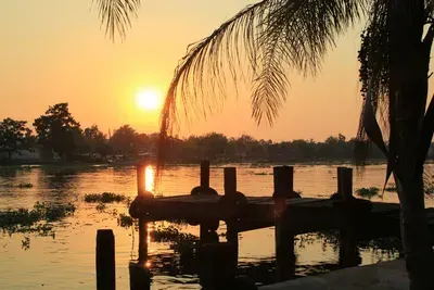 A sunset over a body of water with a dock in the foreground.