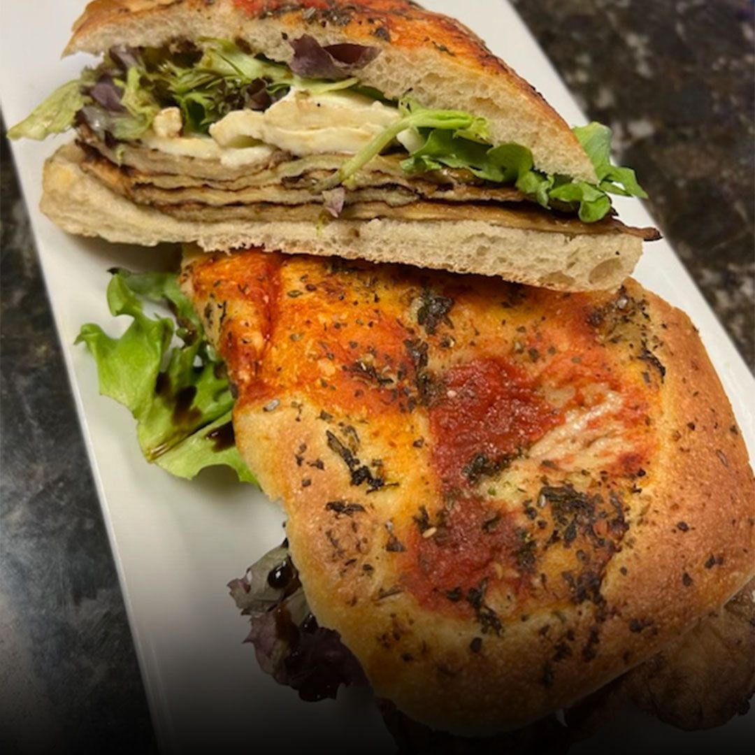 Italian focaccia sandwich with grilled chicken and arugula at Edison Pizza in Edison NJ