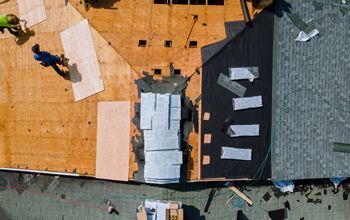 An aerial view of a roof being installed on a house.