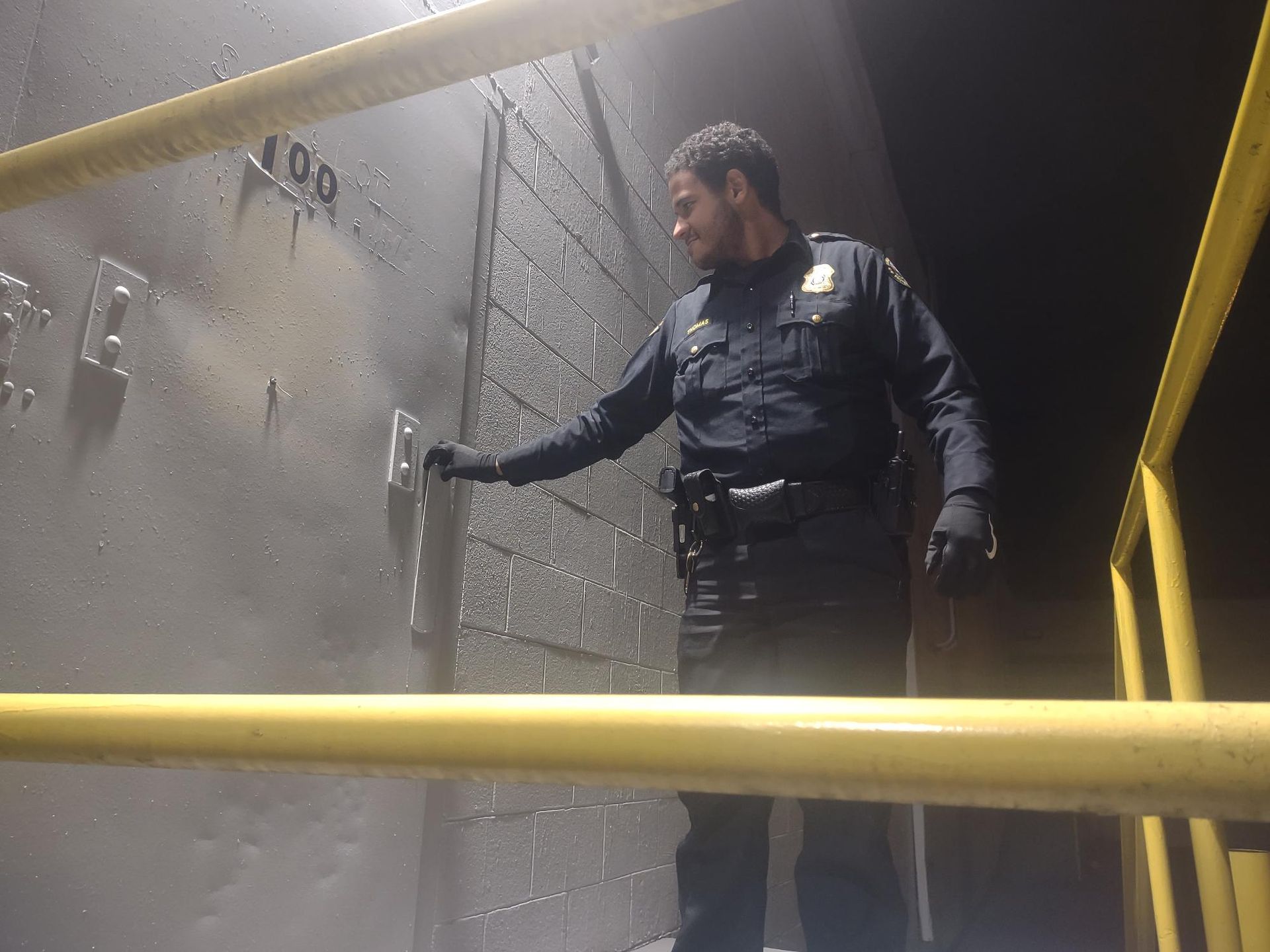 a man in a security uniform checking a locked door