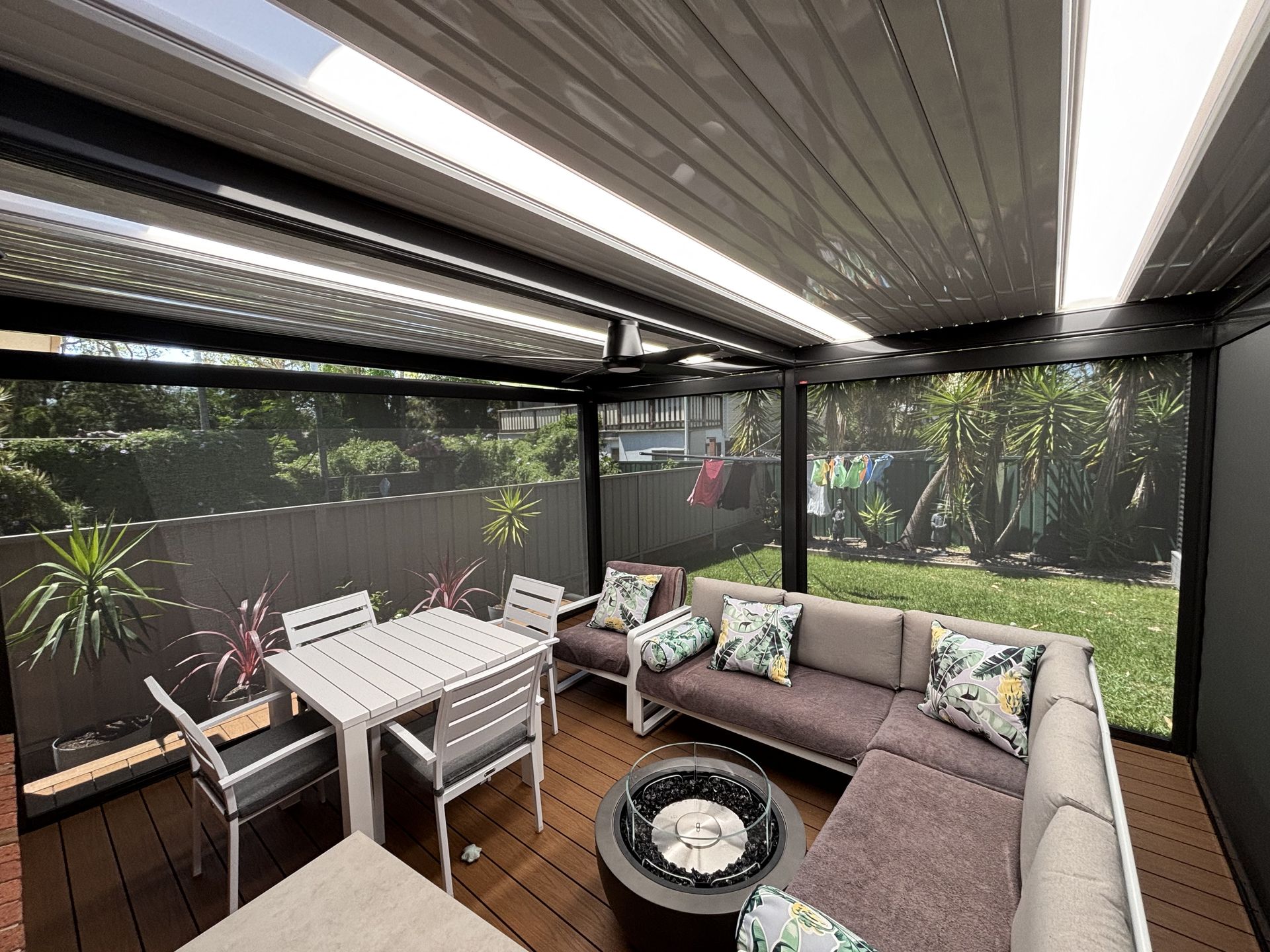 A Balcony With Flowers and a Blind on It — Outdoor Leisure Living In Tuggerah, NSW