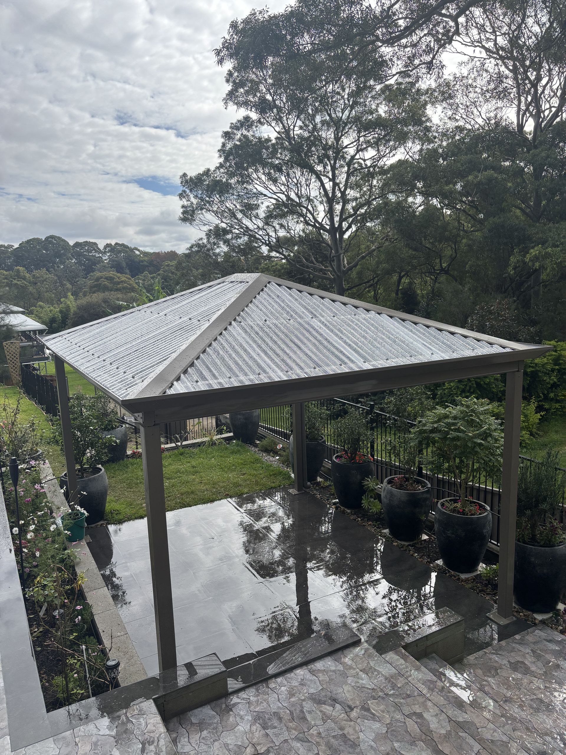 A Wooden Deck With a Fire Pit and a Couch — Outdoor Leisure Living In Tuggerah, NSW
