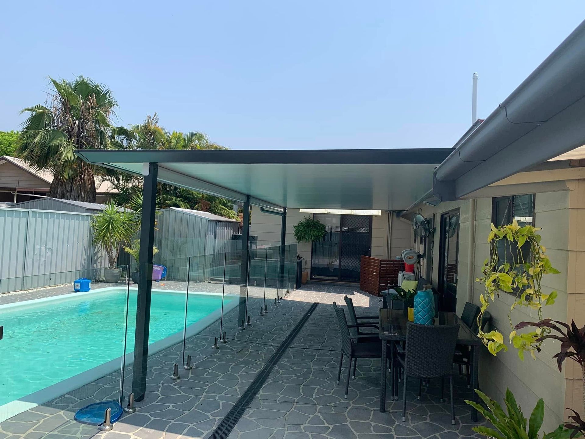 A Patio With a Table and Chairs Under a PergolaIn In The Central Coast