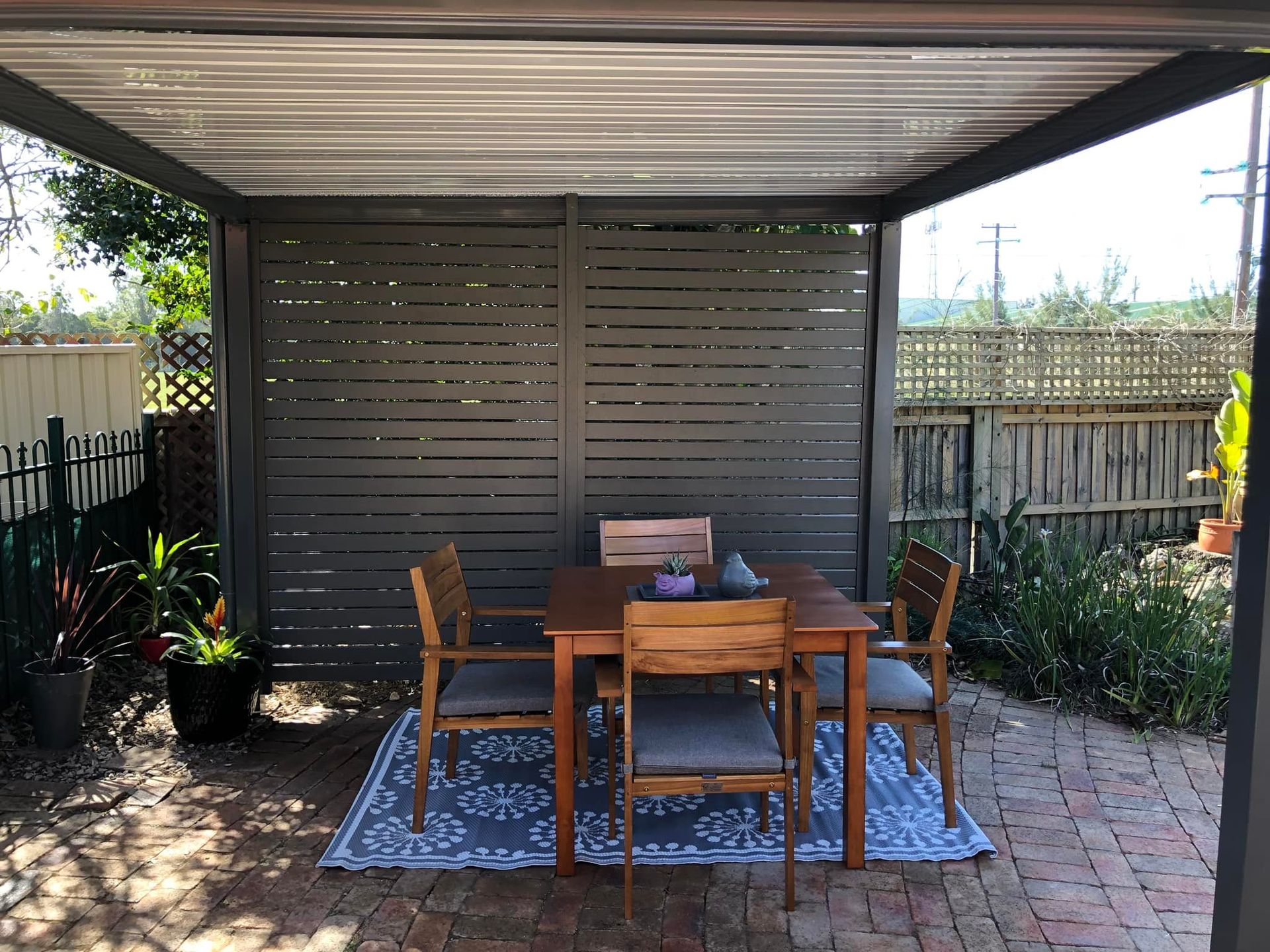 A white house with a porch with black privacy screens around it — Outdoor Leisure Living In Tuggerah, NSW
