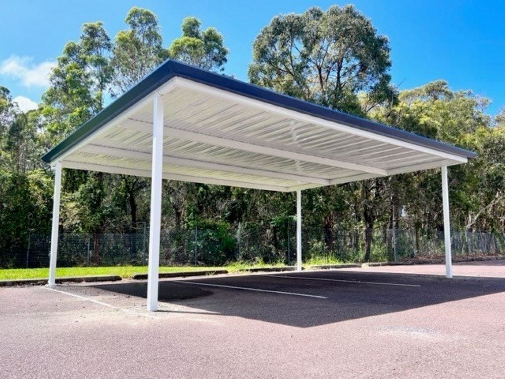 A Carport in a Parking Lot With Trees in the Background — Outdoor Leisure Living In Bateau Bay, NSW