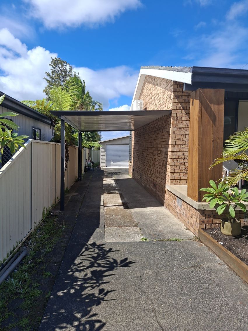 A Driveway Leading to a House With a Carport — Outdoor Leisure Living In Gosford, NSW