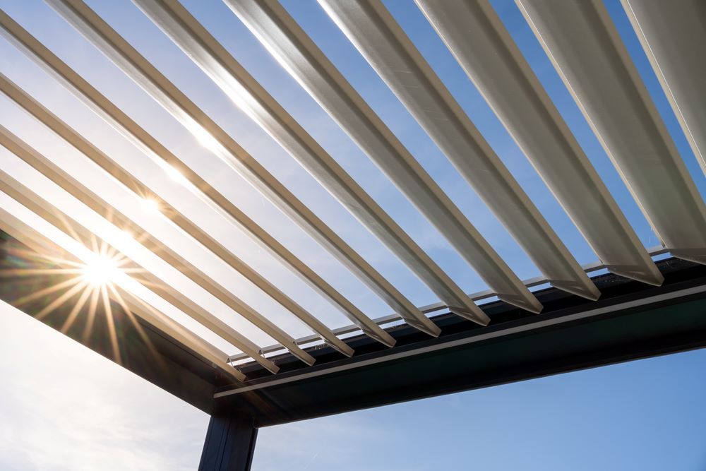 The Sun is Shining Through the Roof of a Pergola — Outdoor Leisure Living In Bateau Bay, NSW