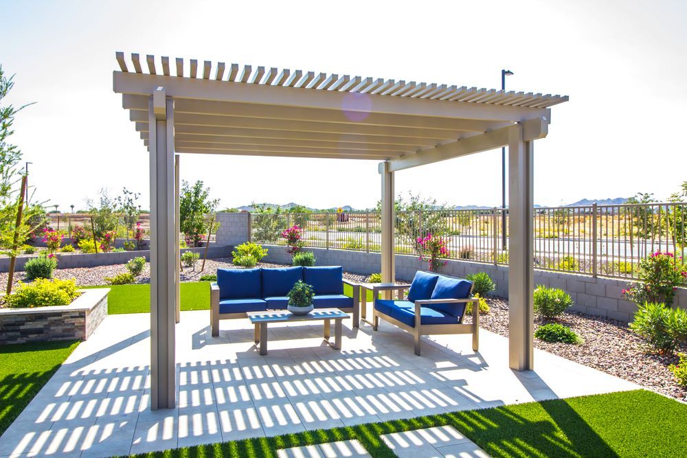 A Pergola With a Couch and Chairs Underneath It in a Backyard In Tuggerah