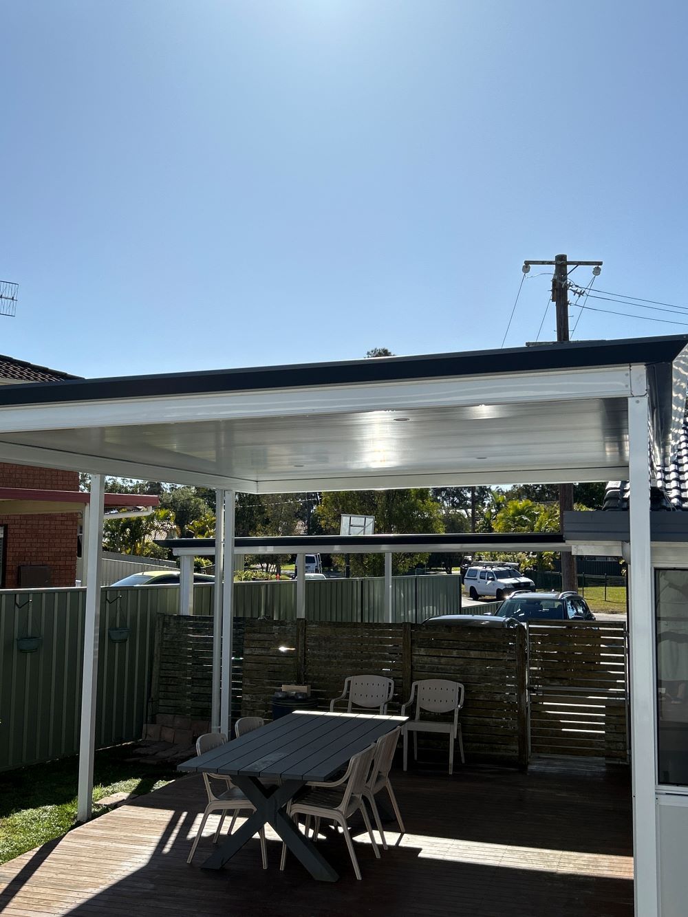 A Patio With a Table and Chairs Under a Pergola In The Central Coast