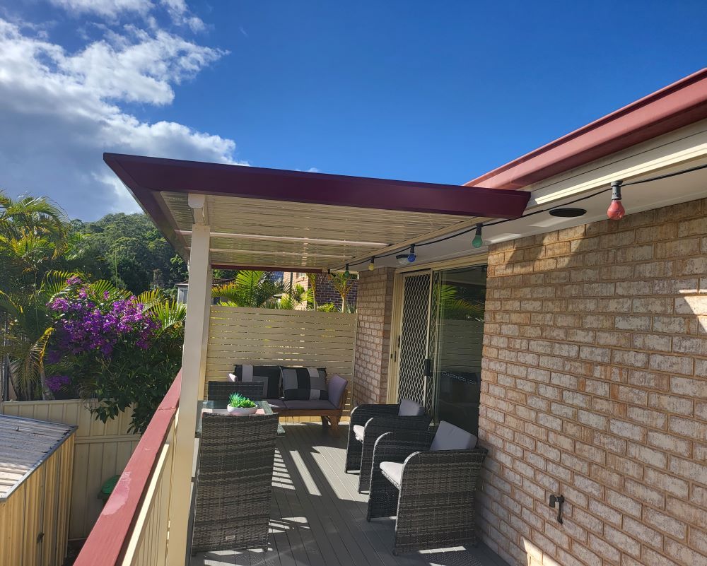 A Brick House With a Patio With Wicker Furniture and a Pergola — Outdoor Leisure Living In Lake Macquarie, NSW
