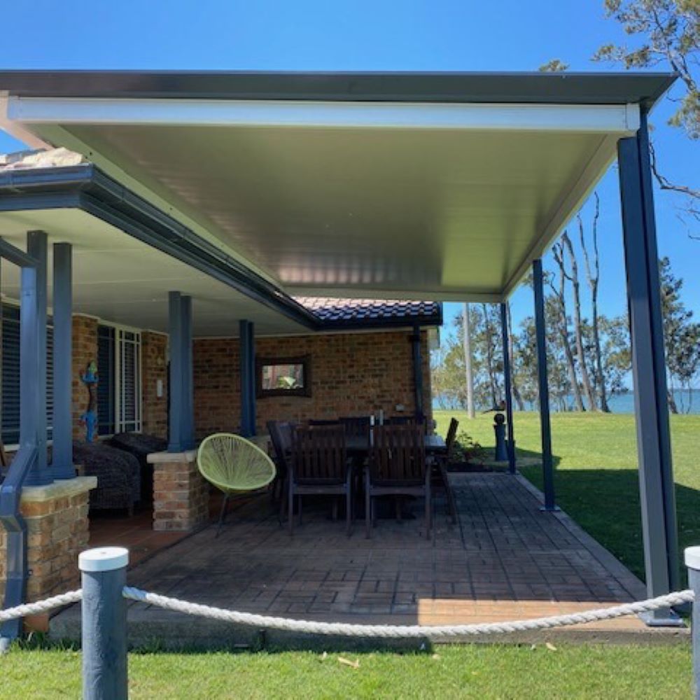 A House With a Covered Patio With a Table and Chairs in Tuggerah