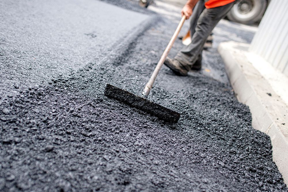Worker Levelling Fresh Asphalt | Jackson, NJ | Certified Asphalt LLC