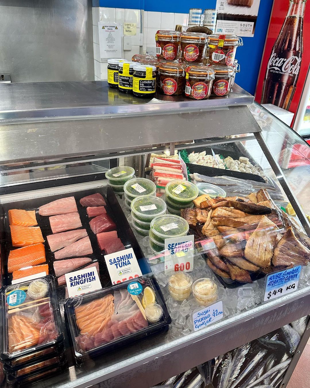A Person Is Holding A Fish In Their Hand In A Fish Market — Northern Rivers Seafood In Ballina, NSW