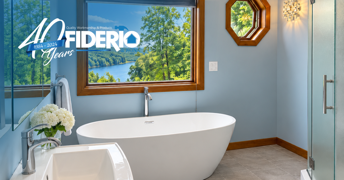 Bright bathroom with a white soaking tub, wood-trimmed window, and a geometric wall mirror.