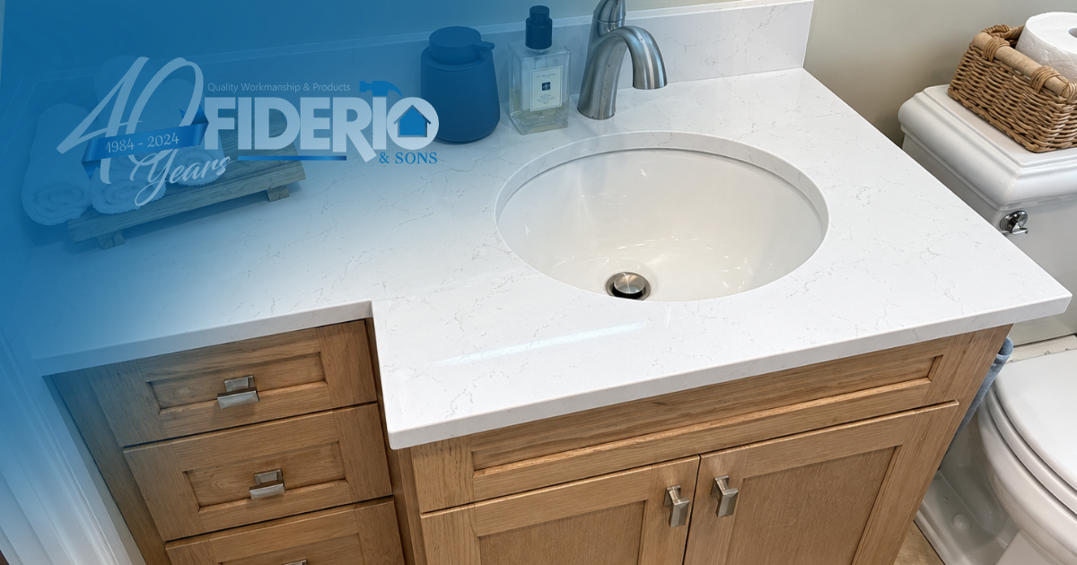 Bathroom vanity with white sink and countertop, wooden cabinets, and a wicker basket on the right.