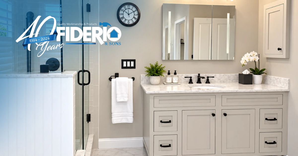 Modern bathroom with white vanity, mirror, towels, and gray walls, featuring a glass shower door.