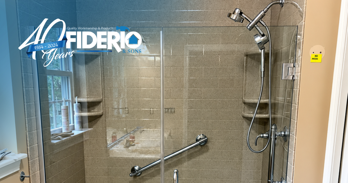 Accessible bathroom with glass shower doors, grab bars, and a shower chair