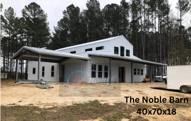 The Noble Barn, a large white metal building with a covered porch, set against a backdrop of pine trees.